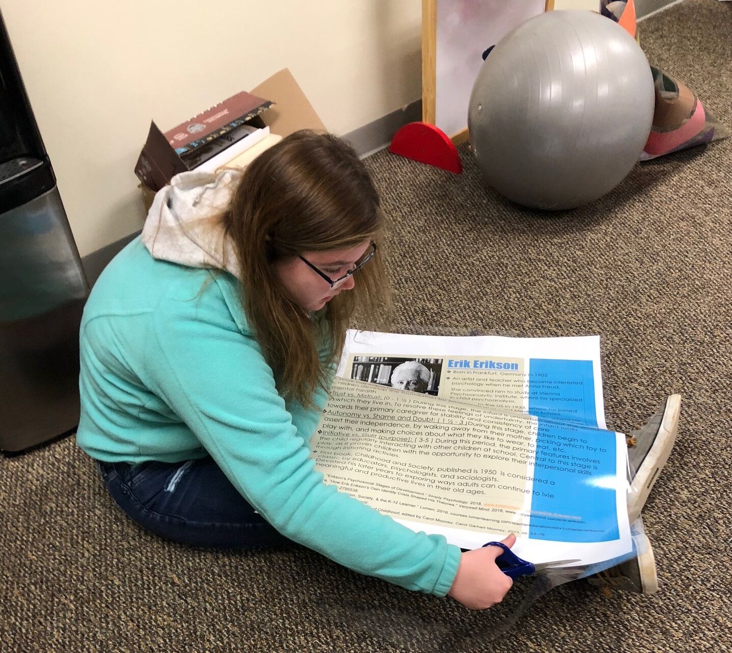 High school student prepares poster.